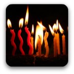 Lit  candles on a birthday cake