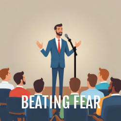 Man standing confidently while speaking into microphone, in front of an audience. Text overlay: Beathing fear