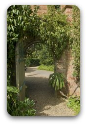 Image: Brick archway leading to a beautiful garden Image: Brick archway leading to a beautiful garden