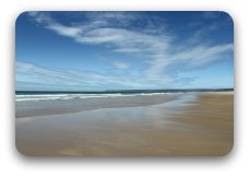 Image: A wide clear open beach: sea, sand and sky meeting each other. Image: A wide clear open beach: sea, sand and sky meeting each other.