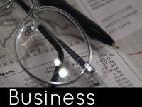 A pair of glasses on top of a stock report - business speech topics.