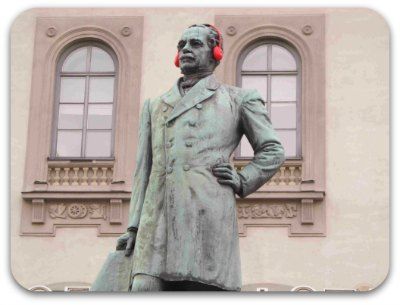 A statue waering a pair of red headphones