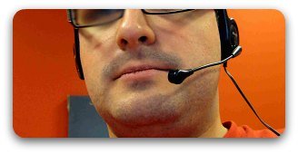 Male call center worker on phone. Male call center worker on phone.